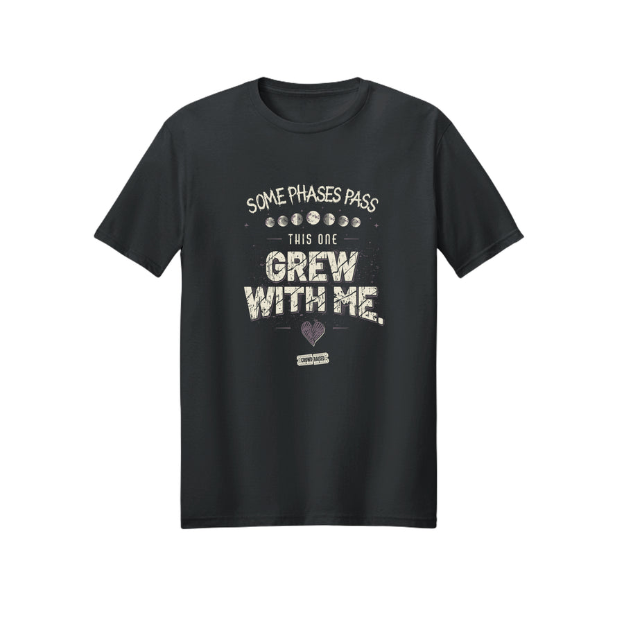 Front of black T-shirt with cream “Some Phases Pass, This One Grew With Me” lettering, moon phases, and a heart graphic.