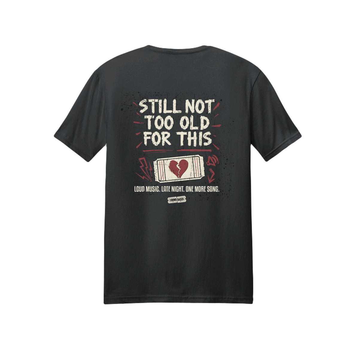Back of black Crowd Raised T-shirt with cream “Still Not Too Old for This” lettering and a red and cream ticket graphic.